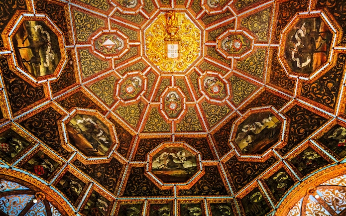 Ceiling of the Hall of Coats of Arms, National Palace of Sintra, with intricate heraldic designs.
