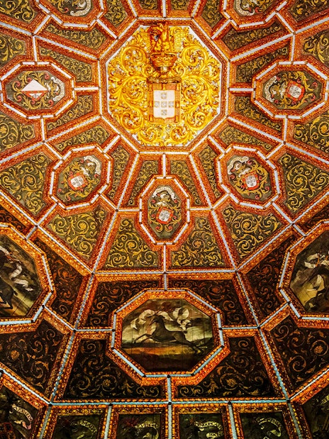 Ceiling of the Hall of Coats of Arms, National Palace of Sintra, with intricate heraldic designs.