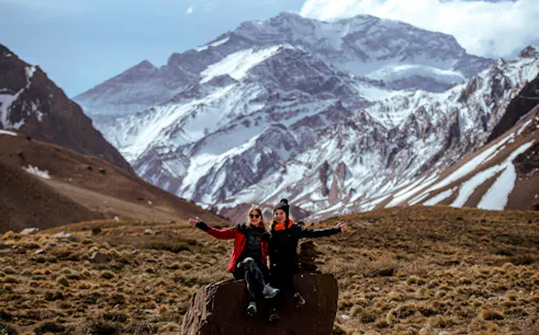Guests enjoying the High Mountain Excursion with a local guide near snow-capped peaks from Mendoza.
