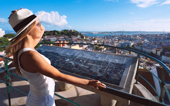 Tourist enjoying the view at Miradouro da Senhora do Monte, Lisbon.