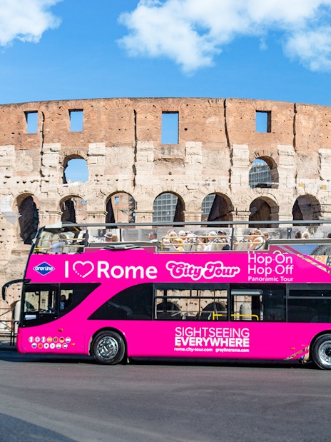 Open-top tour bus in front of the Colosseum, Rome, for I Love Rome Hop-On Hop-Off Tour.