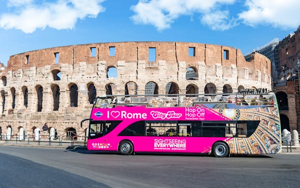 Open-top tour bus in front of the Colosseum, Rome, for I Love Rome Hop-On Hop-Off Tour.