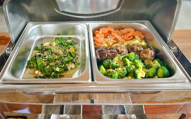 Vegetarian buffet meal at Krabi Roaming Elephant Sanctuary, featuring greens and mixed vegetables.