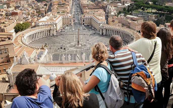 Visitors overlooking St. Peter’s Square from the Basilica Dome Terrace in Vatican City.