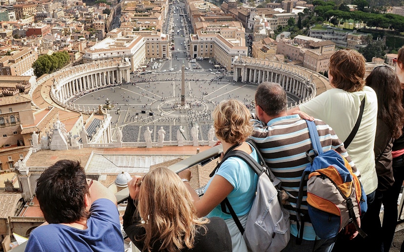 Visitors overlooking St. Peter’s Square from the Basilica Dome Terrace in Vatican City.