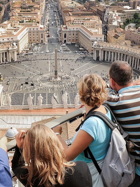 Visitors overlooking St. Peter’s Square from the Basilica Dome Terrace in Vatican City.