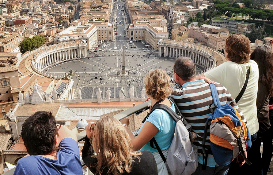 Visitors overlooking St. Peter’s Square from the Basilica Dome Terrace in Vatican City.