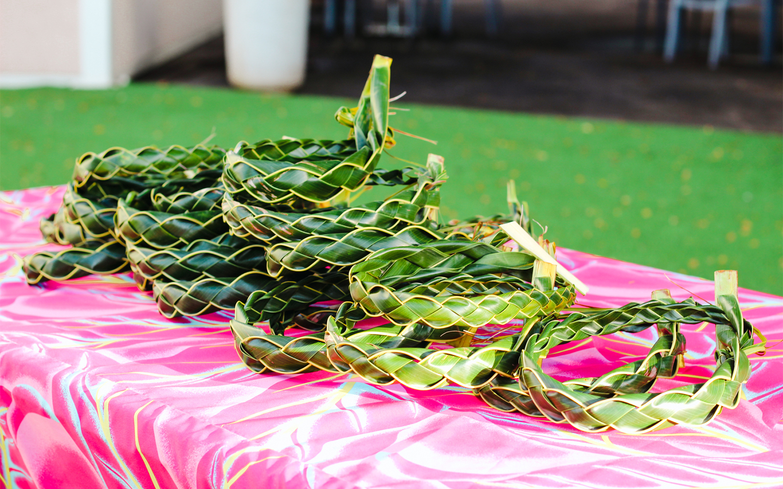 Woven palm leaf headbands on a table at Moana Luau, Hawaii.