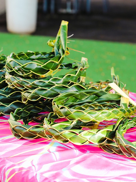 Woven palm leaf headbands on a table at Moana Luau, Hawaii.