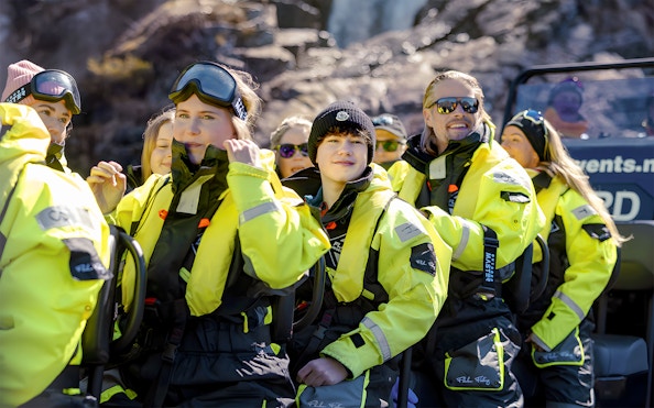 Guests in yellow suits on a RIB boat for Lysefjord Safari with a guide.