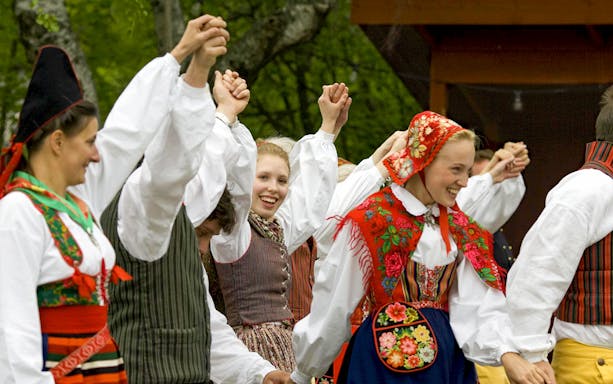 People in traditional Swedish costumes dancing at Skansen Open-Air Museum, Stockholm.