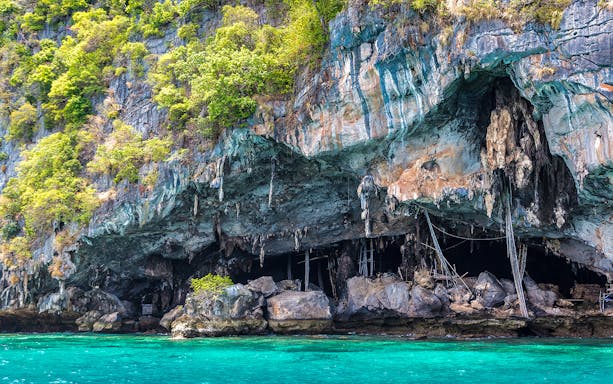 Viking Cave entrance with limestone formations and turquoise water in Phuket.