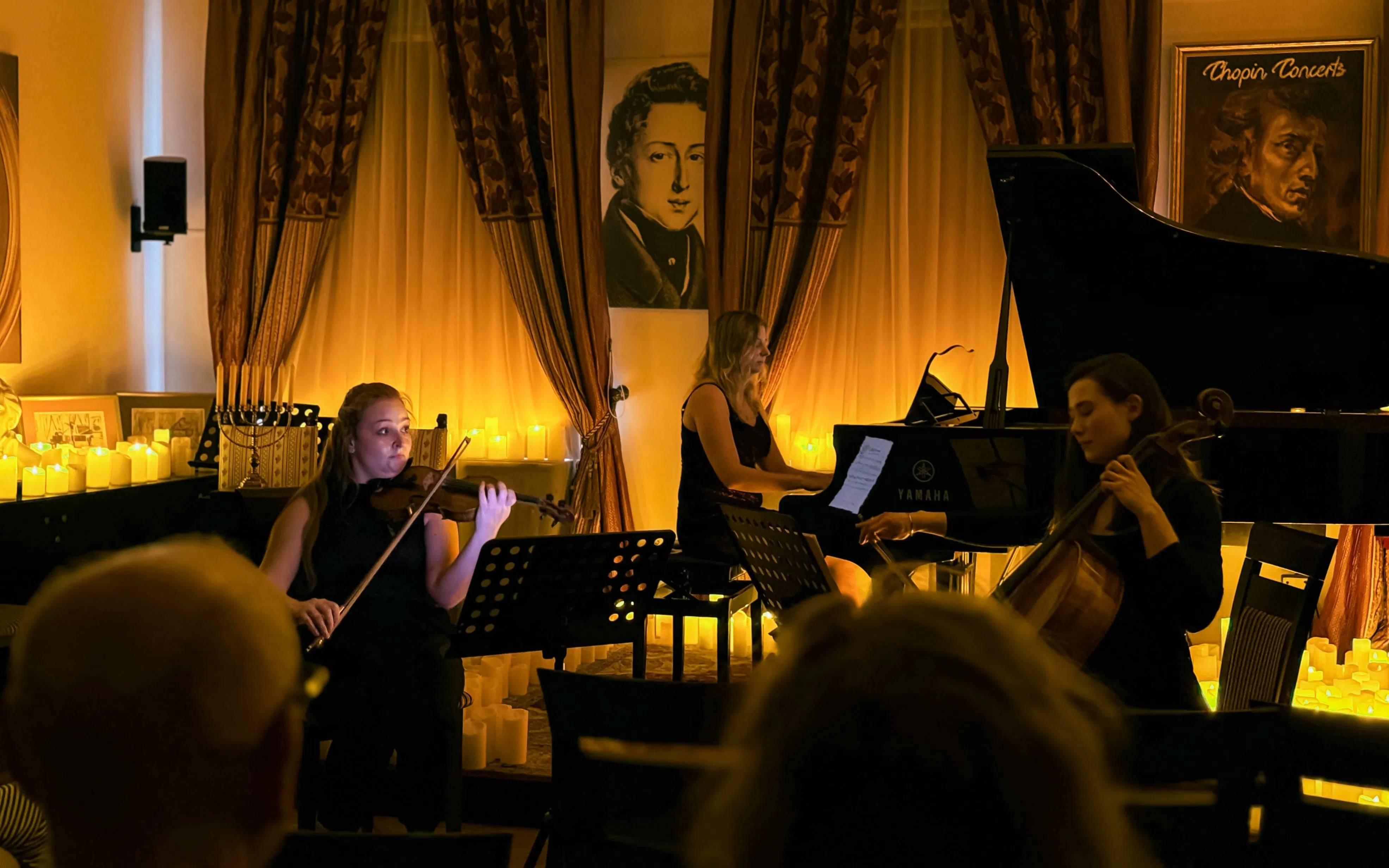 Musicians perform Queen music by candlelight at Chopin Gallery, Krakow.