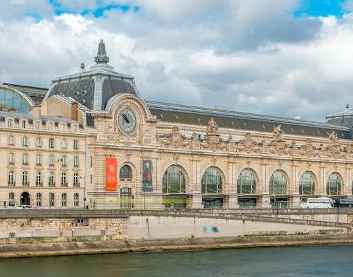 Visitors exploring artwork at Museum D'Orsay, Paris, France.