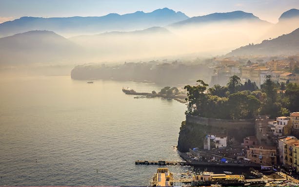 Sorrento coastline with hills and buildings in the background.