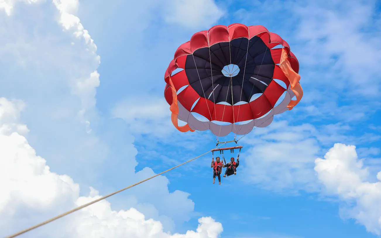 Parasailing over the Red Sea during a glass boat tour in Sharm El Sheikh.