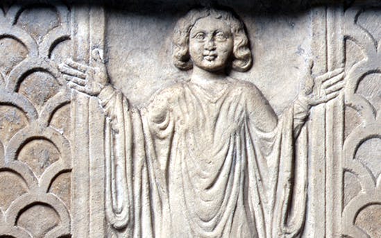 Stone relief of a figure with raised arms in the Catacombs of Saint Agnes, Rome.