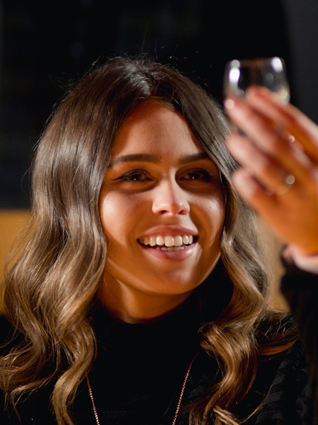 Woman enjoying whiskey tasting at Jameson Distillery tour.