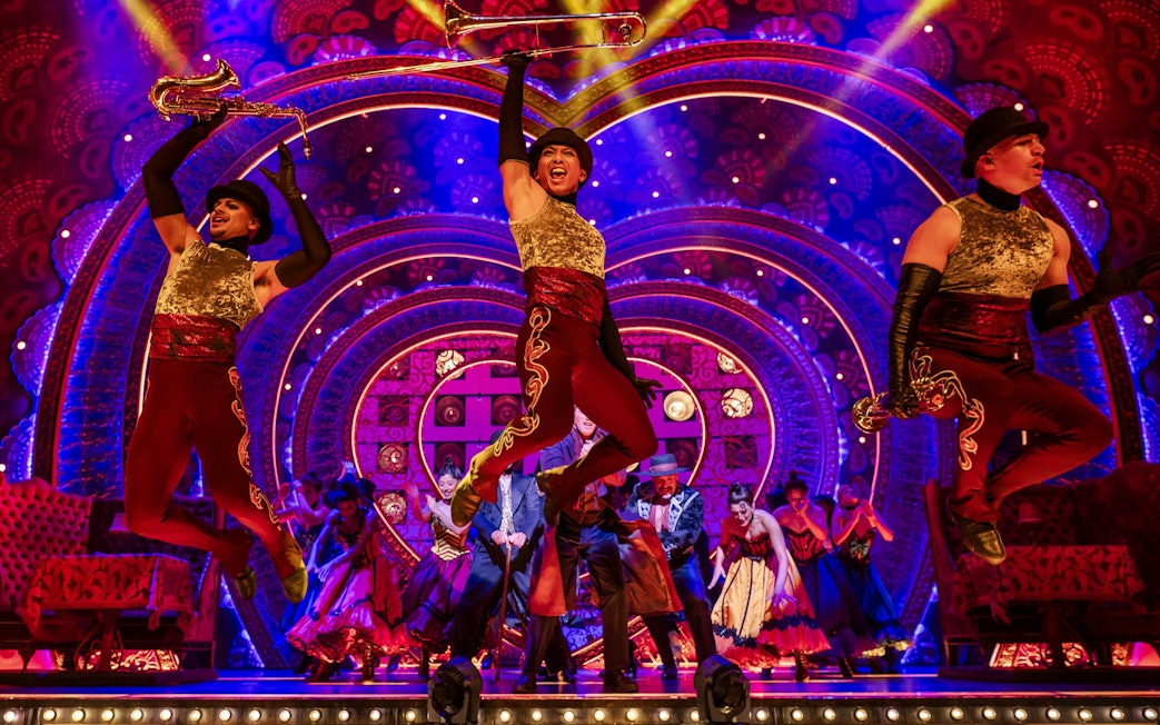 Performers in vibrant costumes on stage during Come Alive Westend show.