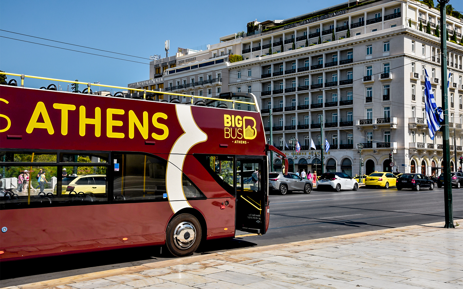 Open-top tour bus in front of Hotel Grande Bretagne, Athens.