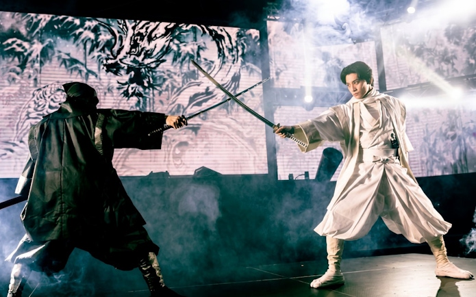 Samurai duel on stage in Tokyo, blending traditional and modern elements.