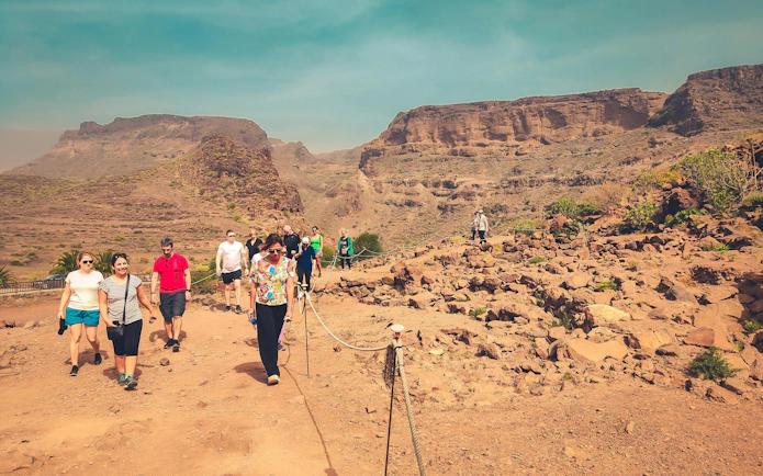 Hikers on a trail at La Fortaleza de Ansite, Santa Lucía de Tirajana, Gran Canaria.