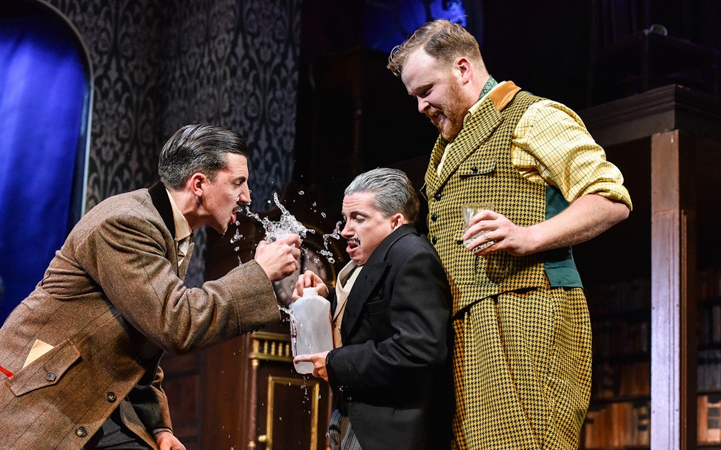 Actors in a comedic scene from "The Play That Goes Wrong" on stage.