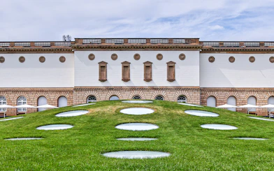 Frankfurt museum building with unique circular skylights on grassy hill.