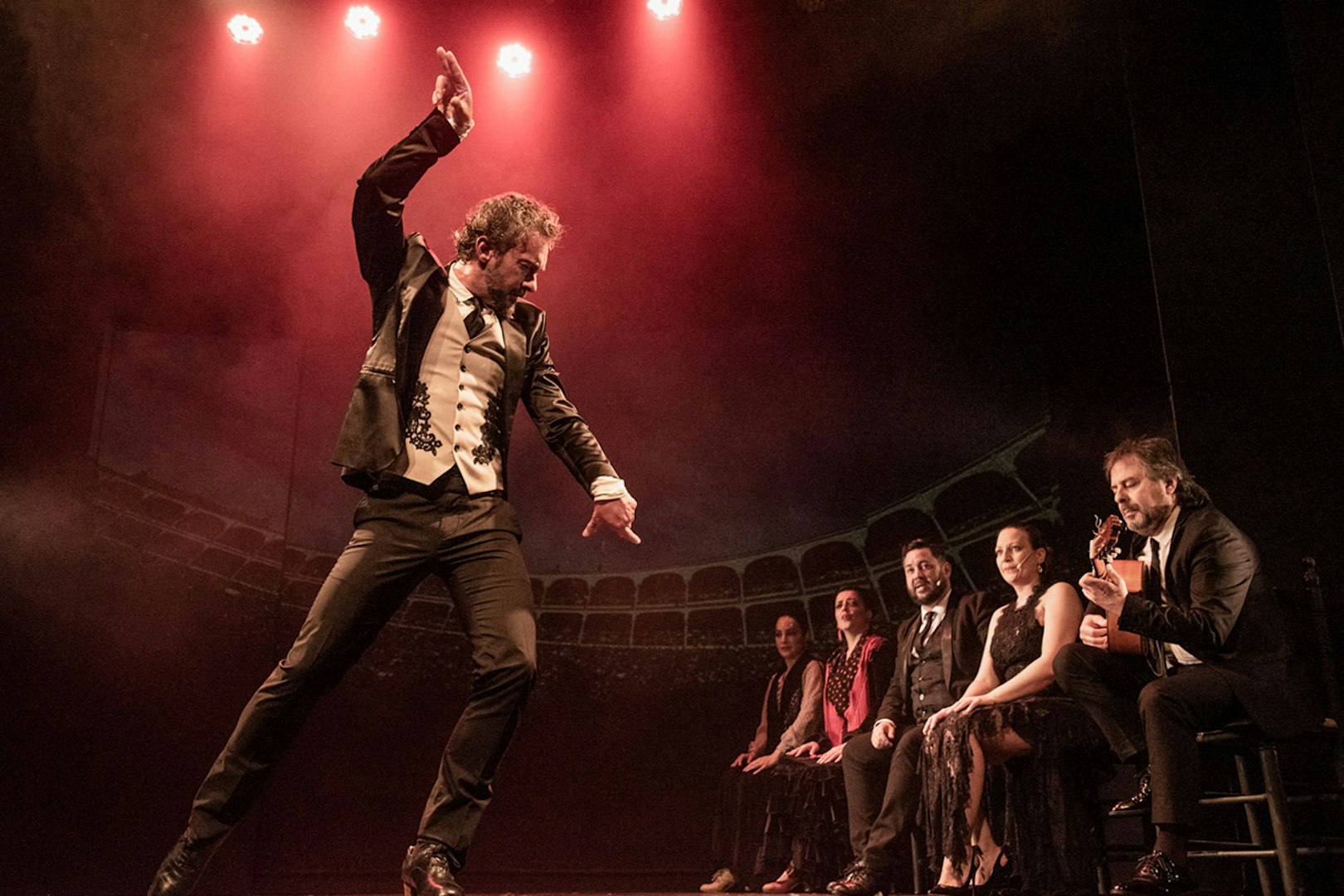 Flamenco dancer performing on stage with musicians at Teatro Flamenco Barcelona.