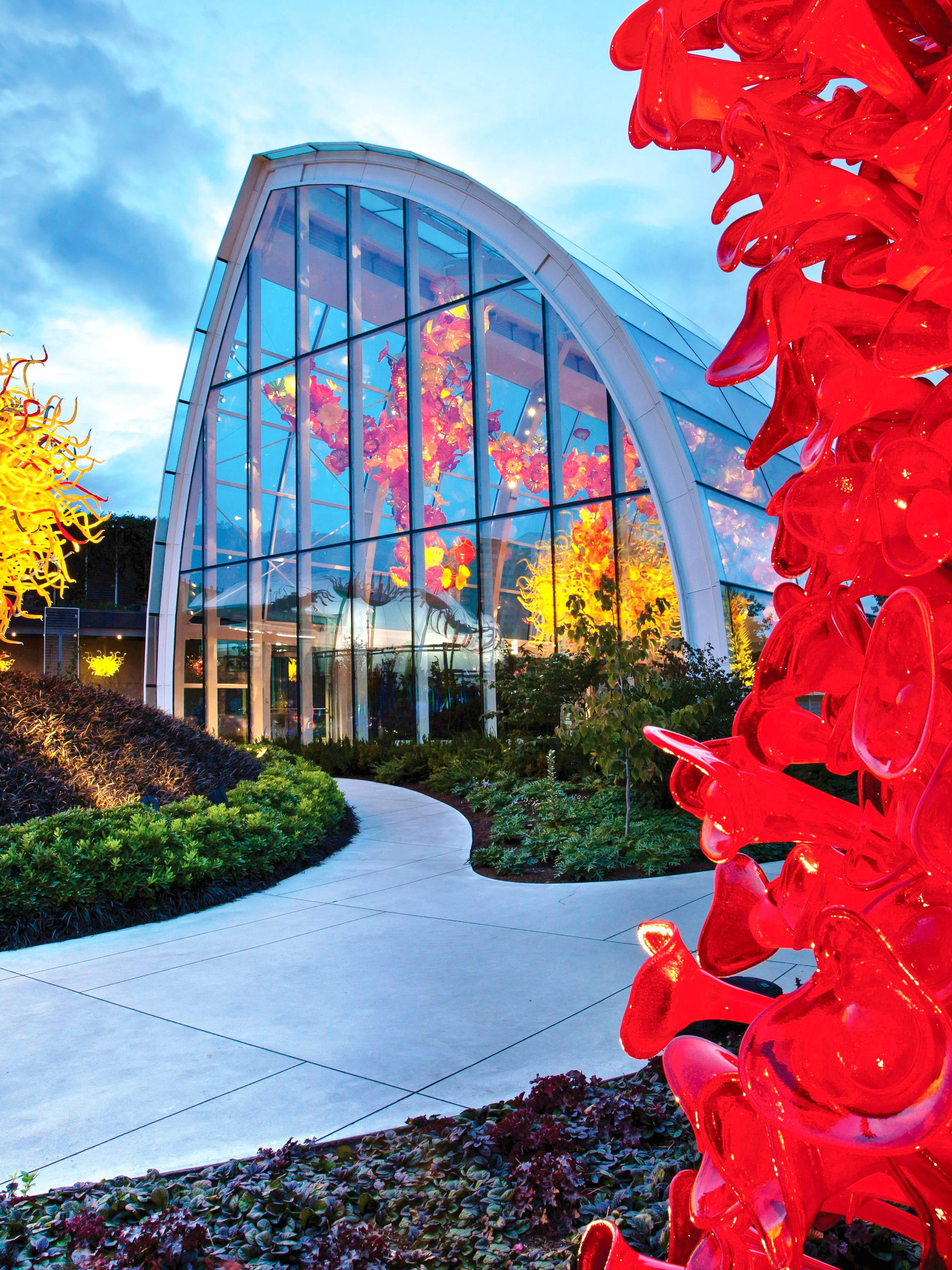 Chihuly Garden and Glass exhibit with vibrant red and yellow glass sculptures in Seattle.