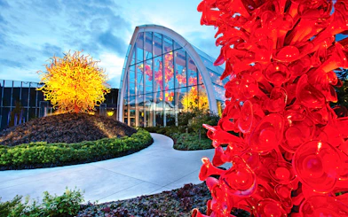 Chihuly Garden and Glass exhibit with vibrant red and yellow glass sculptures in Seattle.