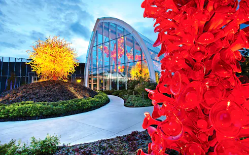 Chihuly Garden and Glass exhibit with vibrant red and yellow glass sculptures in Seattle.