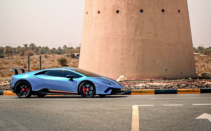 Lamborghini Huracán LP 640-4 Performante parked near a desert tower.