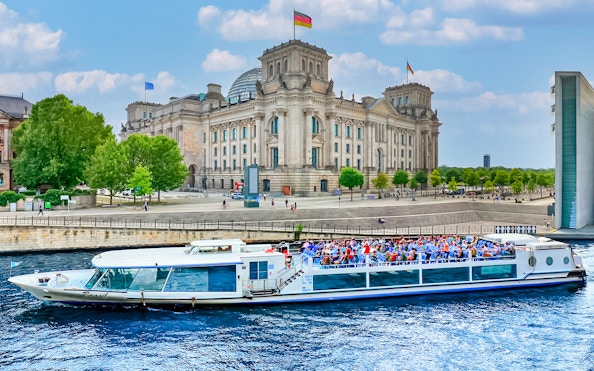 Boat on River Spree passing Reichstag building during Berlin canal tour.