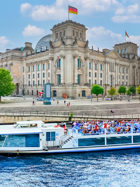Boat on River Spree passing Reichstag building during Berlin canal tour.