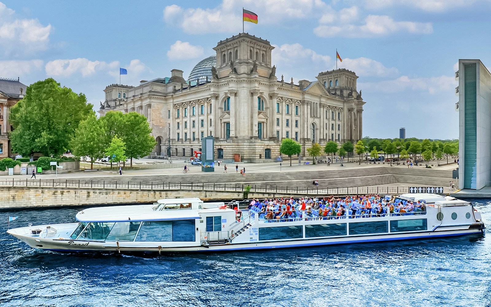 Boat on River Spree passing Reichstag building during Berlin canal tour.