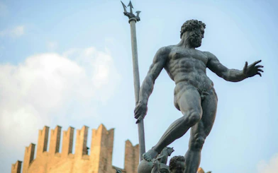 Neptune statue in Bologna's Piazza Maggiore, part of the self-guided city exploration game.