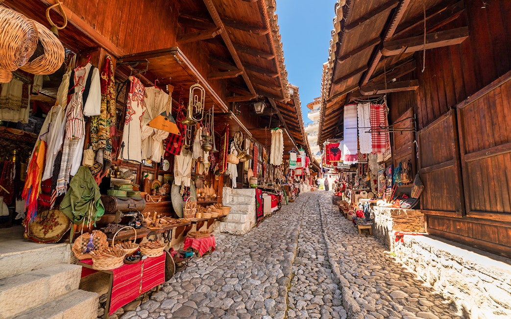 Cobblestone street lined with traditional shops in the Old Bazaar, Kruja.