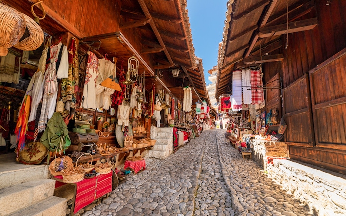 Cobblestone street lined with traditional shops in the Old Bazaar, Kruja.