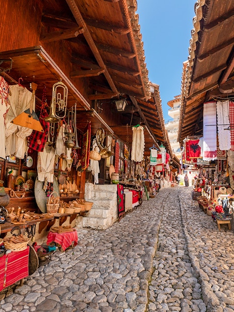 Cobblestone street lined with traditional shops in the Old Bazaar, Kruja.