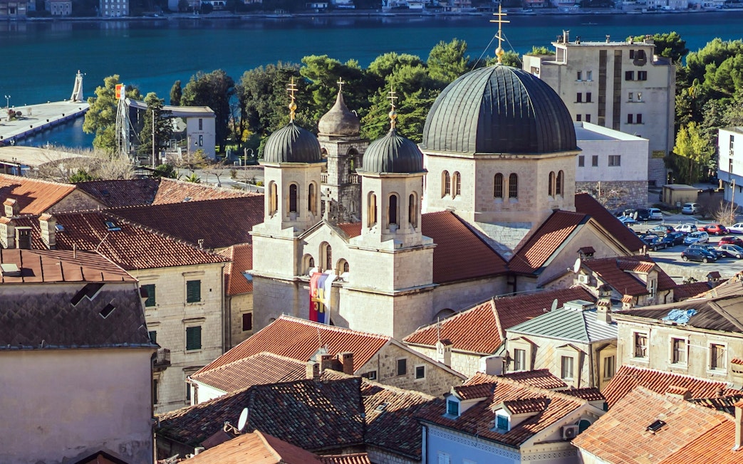 Old Town of Kotor with church domes and red rooftops by the Bay of Kotor, Montenegro.