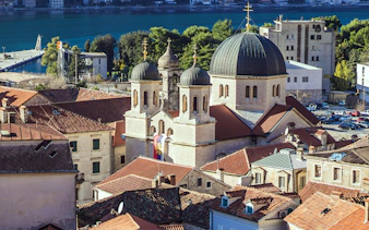 Old Town of Kotor with church domes and red rooftops by the Bay of Kotor, Montenegro.