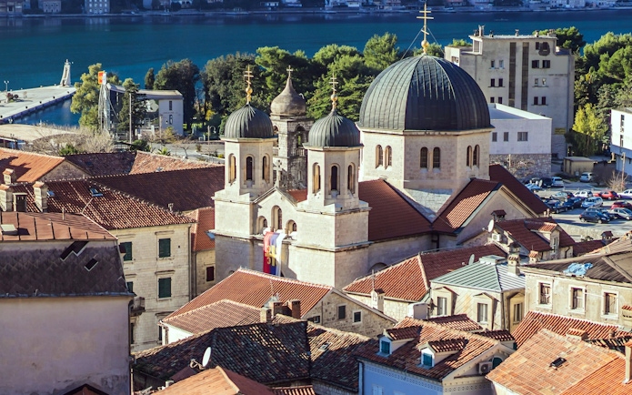 Old Town of Kotor with church domes and red rooftops by the Bay of Kotor, Montenegro.