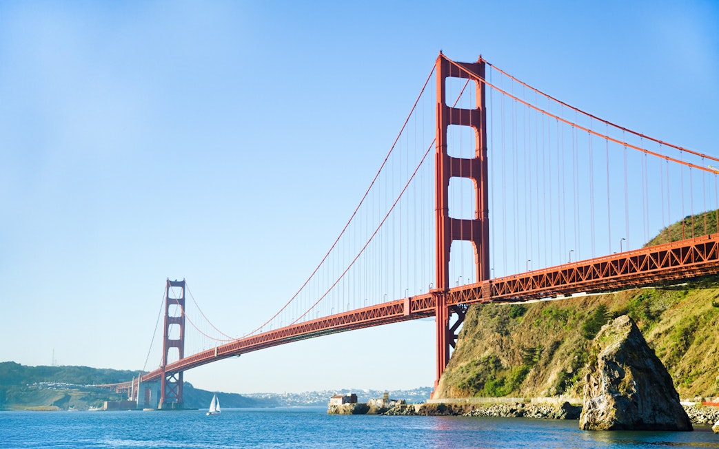 Golden Gate Bridge spanning San Francisco Bay with a sailboat below.