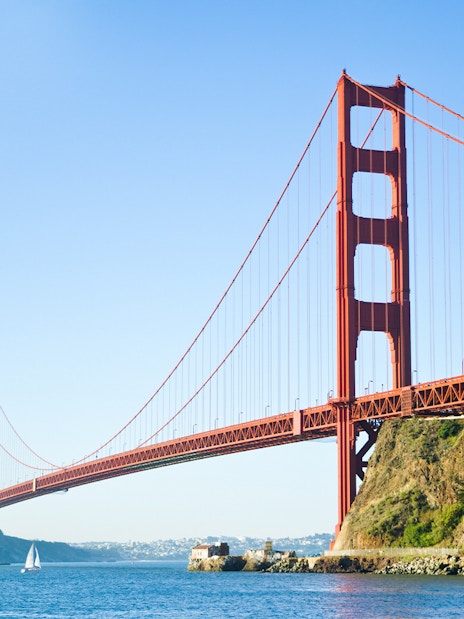 Golden Gate Bridge spanning San Francisco Bay with a sailboat below.