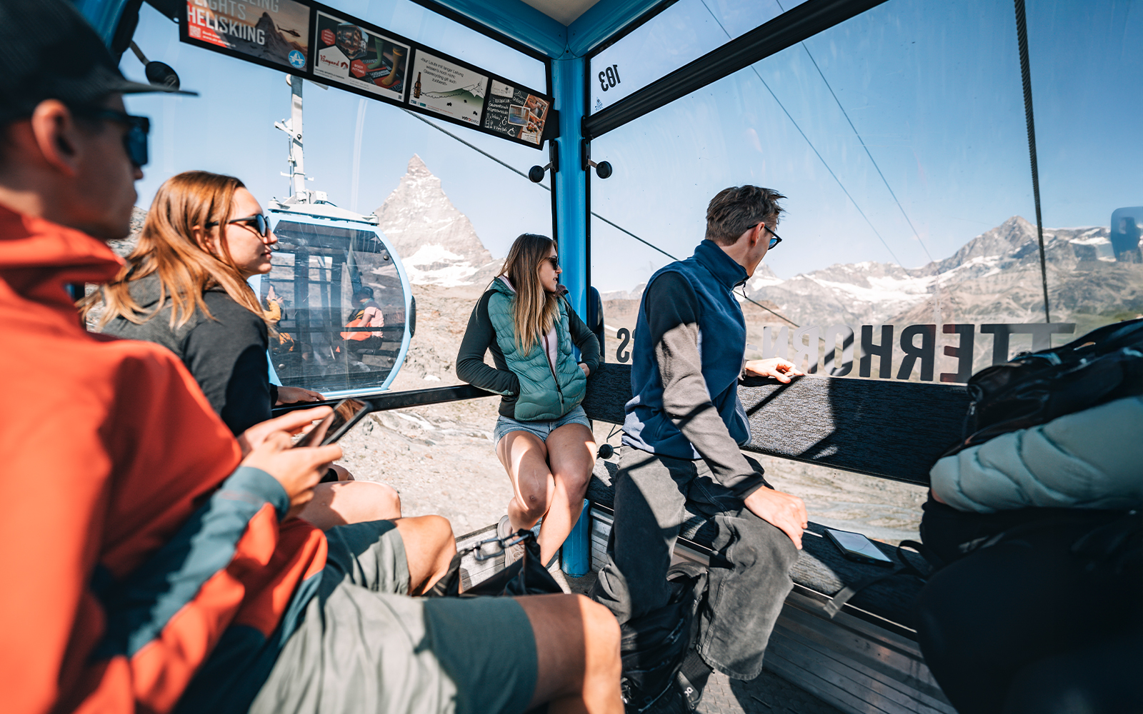 Tourists inside cable car with view of Matterhorn Glacier in Switzerland.