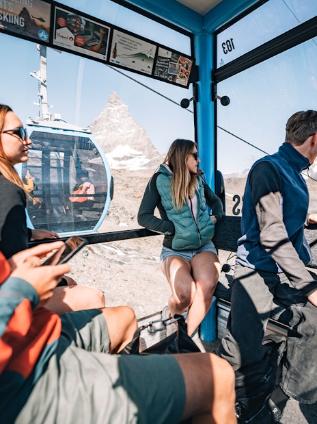Tourists inside cable car with view of Matterhorn Glacier in Switzerland.