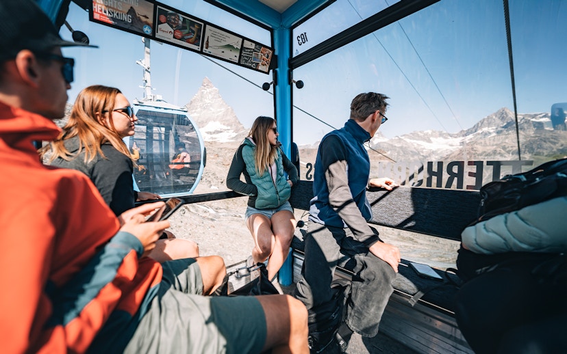 Tourists inside cable car with view of Matterhorn Glacier in Switzerland.