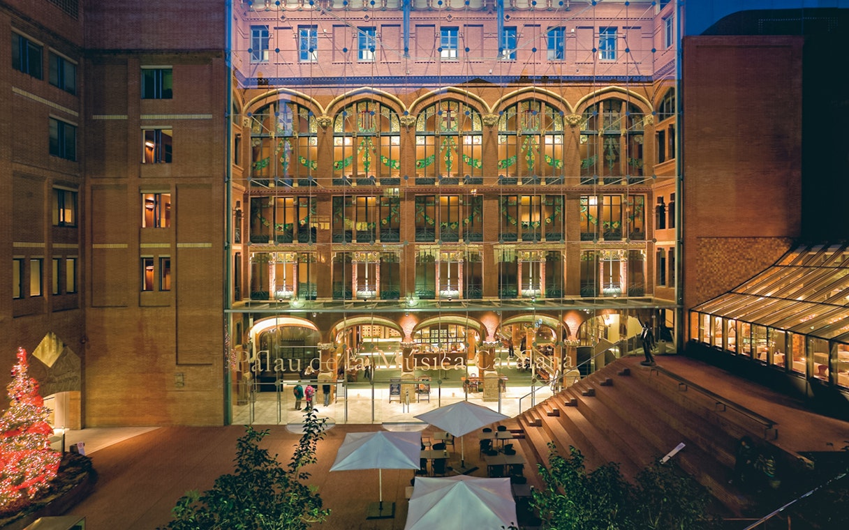 Palau de la Música Catalana entrance with illuminated facade in Barcelona.
