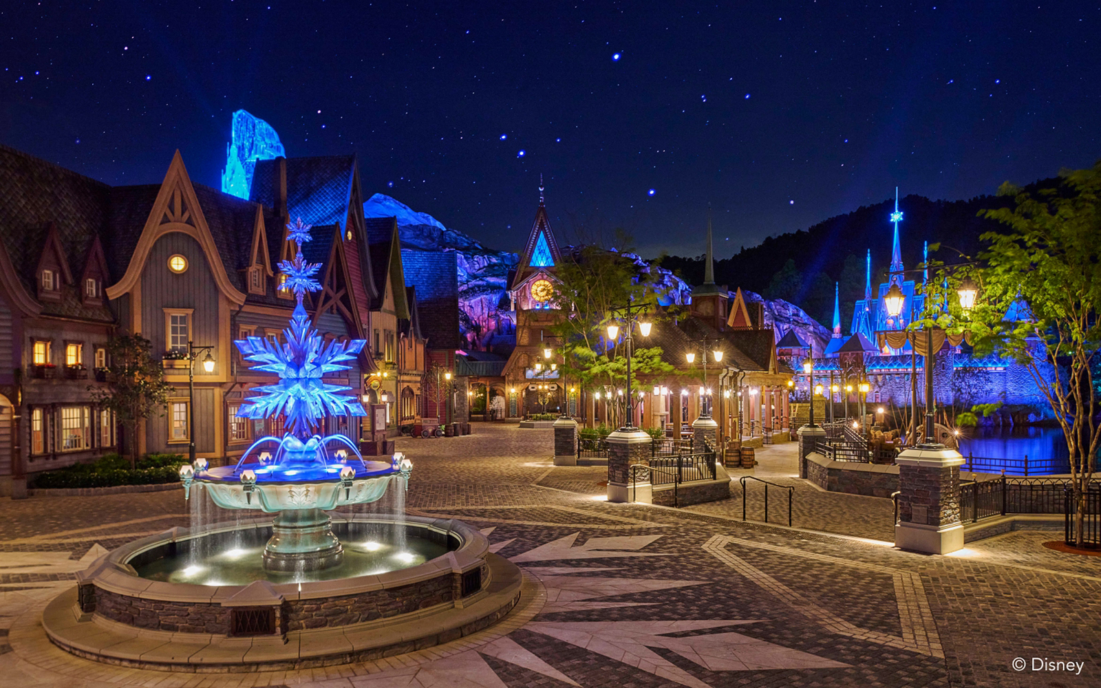 Illuminated Frozen Ever After attraction at night, Disneyland Hong Kong.